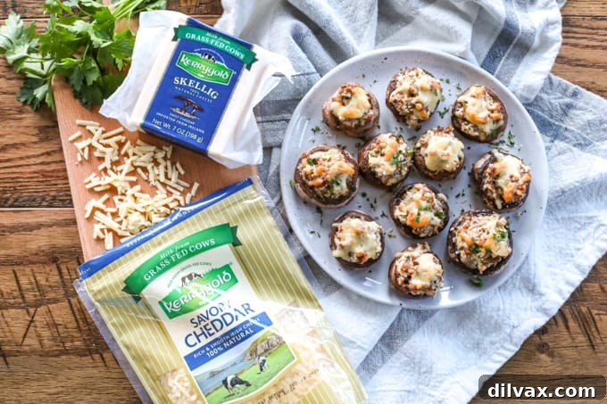 Kerrygold cheeses with a plate of Cheesy Sausage Stuffed Mushrooms. A plateful of Cheesy Sausage Stuffed Mushrooms with Kerrygold cheeses.