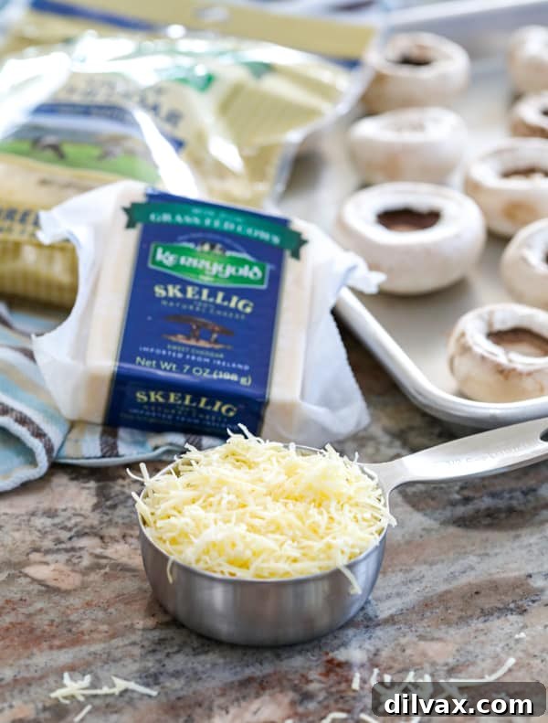 Kerrygold Skellg and Shredded Savory Cheddar cheeses are used in this Cheesy Sausage Stuffed Mushroom recipe. Grated Kerrygold Skellig cheese and Kerrygold Shredded Savory Cheddar for Cheesy Sausage Stuffed Mushrooms.