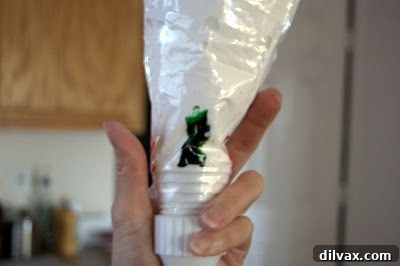 Meringue mixture being spooned into a pastry bag.