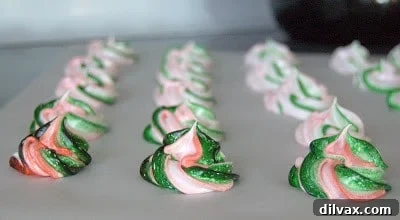 Meringues piped onto a baking sheet, ready for baking.