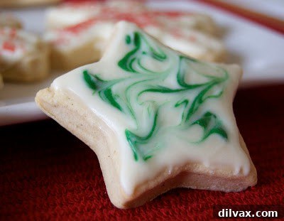 A close-up of a decorated pumpkin spice white chocolate cookie.
