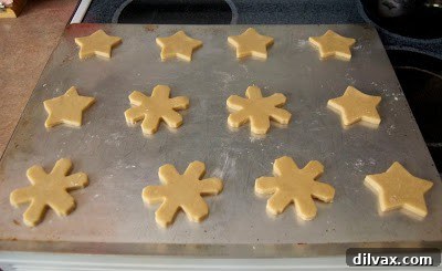 A close-up of a perfectly decorated pumpkin spice white chocolate cookie.