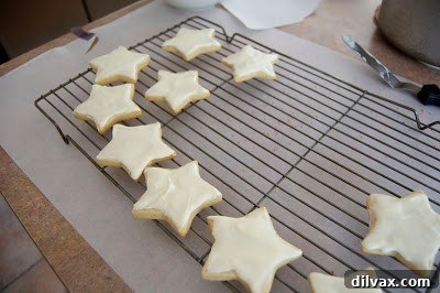 Pile of pumpkin spice white chocolate cookies with various decorations.