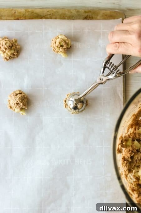 Putting cookie dough on a cookie sheet.