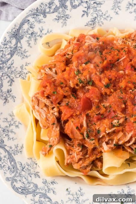 Hearty Braised Pork Ragu 7 Delicious pork ragu with pasta on a white plate