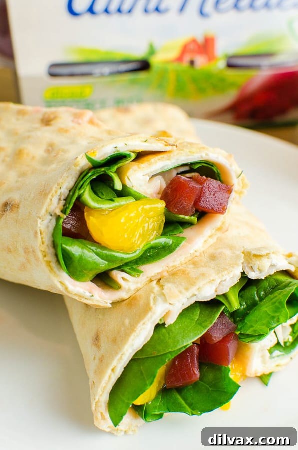 A perfectly rolled Beet, Turkey, and Cheese Wrap featuring Aunt Nellie's Beets, sliced and ready to be enjoyed.
