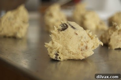 Decadent Chocolate Caramel Toffee Cookies 6 A freshly baked Triple Chocolate Toffee Caramel Cookie, showcasing its texture and delicious toppings.