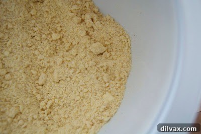 Butter skillfully cut into the flour mixture for the galette crust, creating a textured blend that resembles coarse meal.