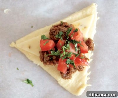 Taco Pocket cut in half, showing the cheesy beef and tomato filling