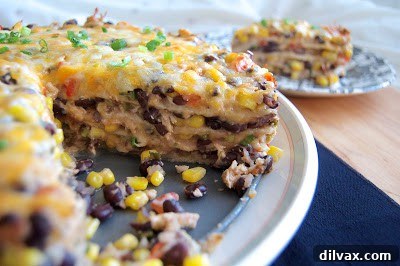 A springform pan containing the layered Chicken, Black Bean and Tortilla Pie, ready for the oven.