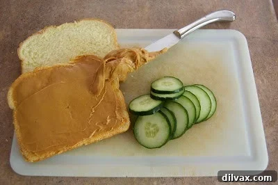 Nutty Cucumber Crunch 9 A top-down view of two halves of a peanut butter and cucumber sandwich, neatly presented.