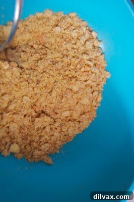 Tilapia Dinner Idea A vertical shot of two crispy breaded tilapia fillets on a plate with a side of colorful fruit salsa.