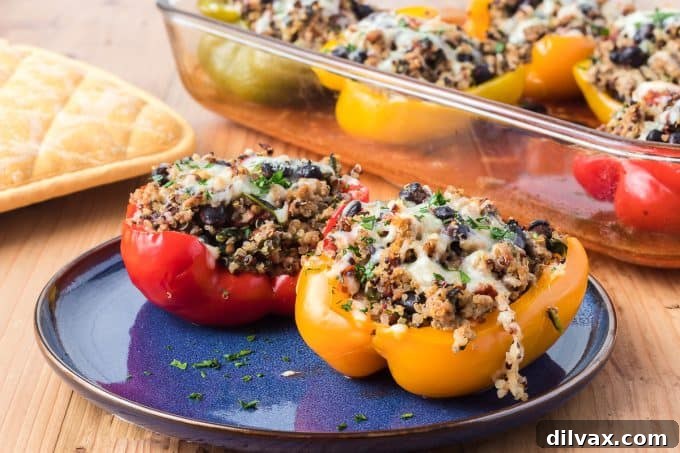 Colorful Quinoa, Black Bean and Turkey Stuffed Peppers in a baking dish, ready to be served.