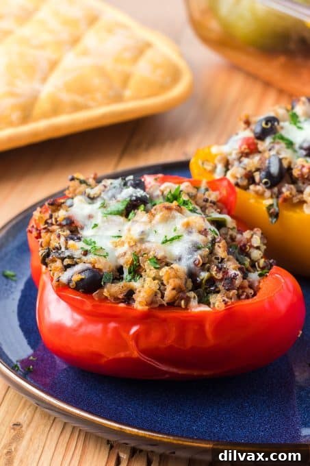 Close-up of a perfectly baked Quinoa, Black Bean and Turkey Stuffed Pepper, showing the golden cheese topping.