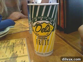Close-up of the distinctive yellow and green cup of Del's Frozen Lemonade.