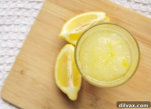 Close-up of a glass of homemade frozen lemonade with lemon slices.