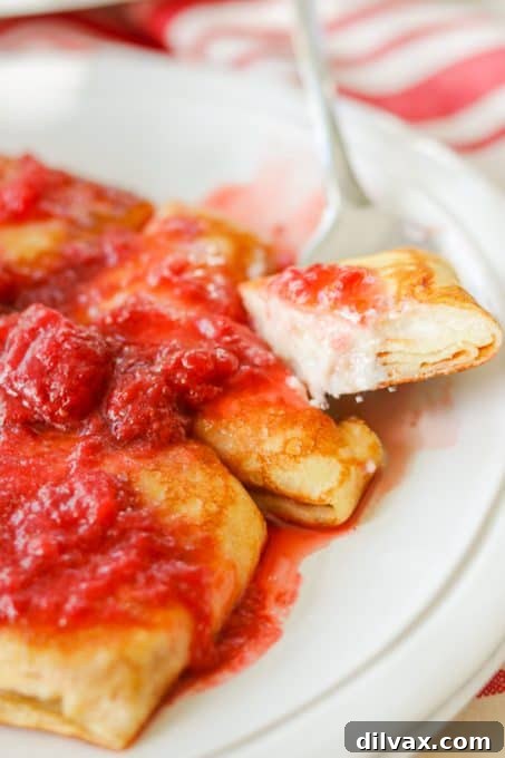 Unlock the Secrets to Perfect Cheese Blintzes 12 A bite taken out of a cheese-filled blintz.