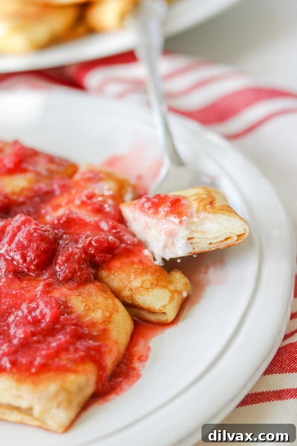 Unlock the Secrets to Perfect Cheese Blintzes 16 A bite of Cheese Blintz on a fork.