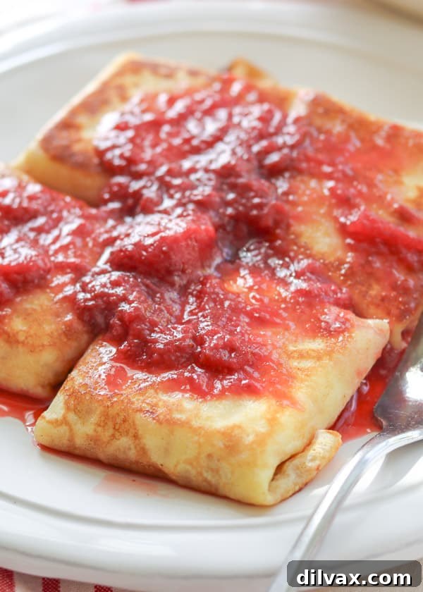 Unlock the Secrets to Perfect Cheese Blintzes 17 The ultimate Cheese Blintzes covered in strawberry sauce.