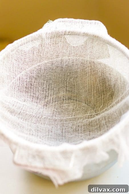 Unlock the Secrets to Perfect Cheese Blintzes 5 Lining a bowl with cheesecloth to drain the cottage cheese for blnitzes.