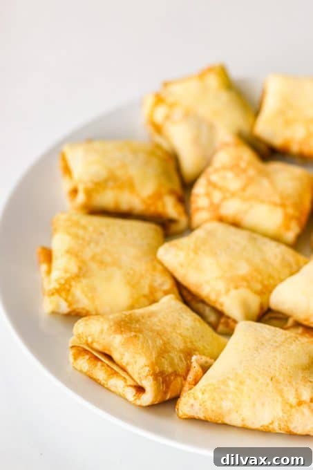 Unlock the Secrets to Perfect Cheese Blintzes 6 Crepes filled with cheese ready to be fried.