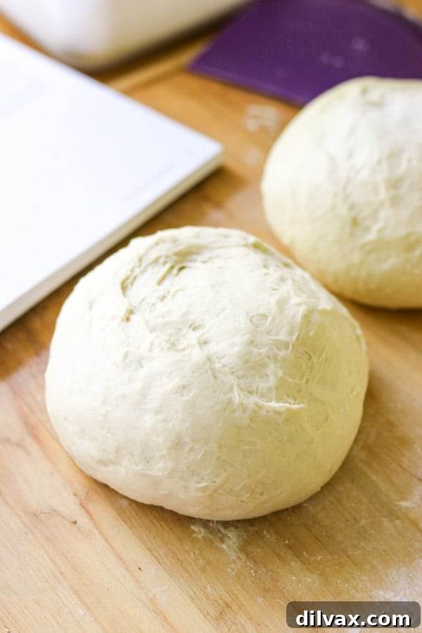 Dough ready to make pizza! One recipe that makes 3 pizza crusts. Three balls of pizza dough ready on a floured surface.