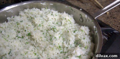 Zesty Cilantro Lime Rice 8 Fluffing Cilantro Lime Rice with a fork and adding cilantro