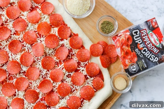 Slices of HORMEL® Cup N' Crisp Pepperoni Bold, ready for baking