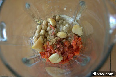 Person holding hummus dip with pita chips