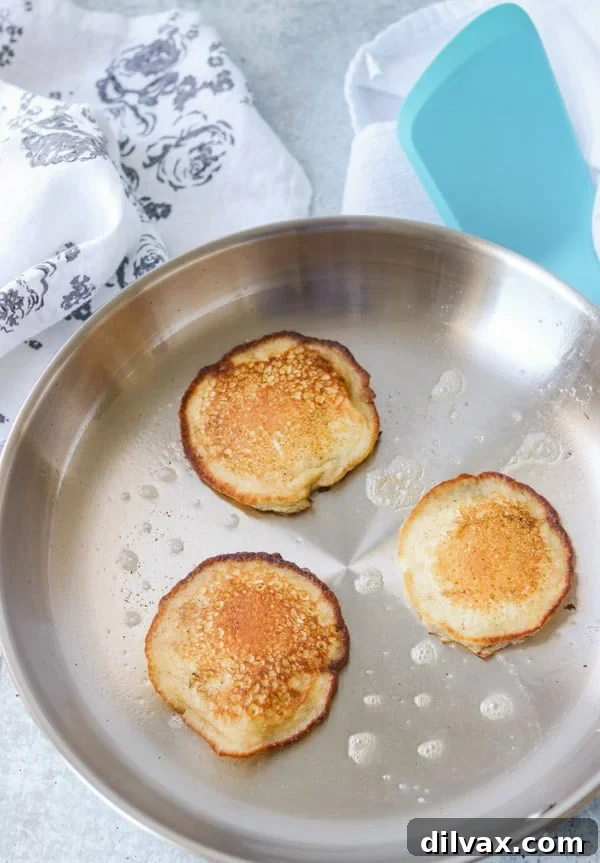 A skillet with cooked griddle cakes.