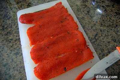 Perfectly peeled and deseeded roasted red pepper, showcasing its vibrant color and tender texture.