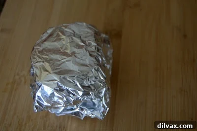 Garlic head wrapped in aluminum foil