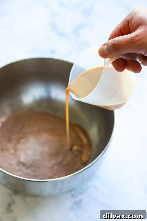 Pouring Baileys in to chocolate pudding mix. Pouring Baileys Irish Cream into chocolate pudding mix.