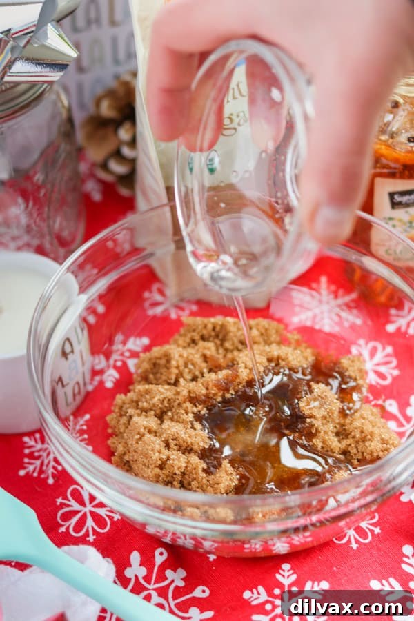 Pouring coconut oil into brown sugar to make a scrub.