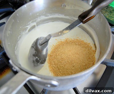 Mixing graham cracker crumbs with marshmallows