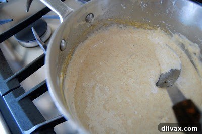 Rice Krispies cereal being mixed into the marshmallow mixture