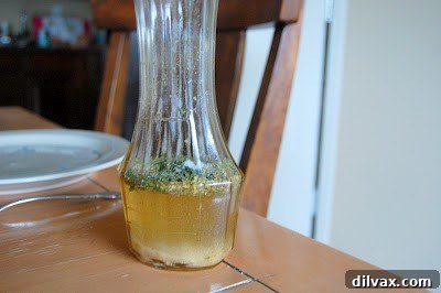 Olive oil being added to dressing ingredients