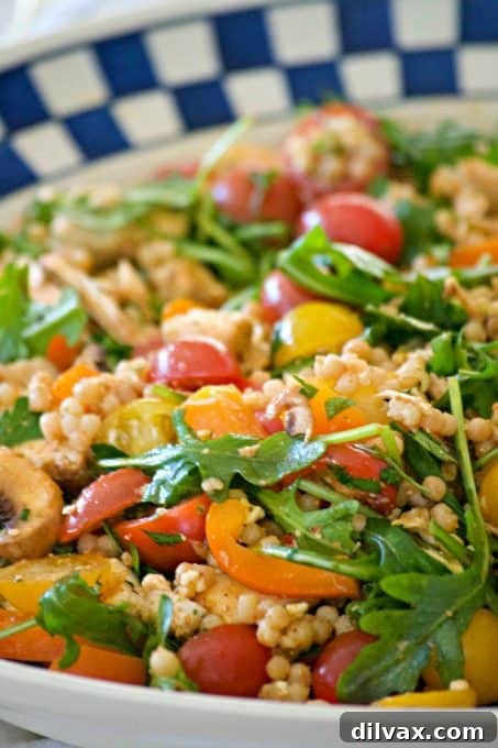 This delicious and easy Couscous Chicken Salad is made with pearl couscous, chicken, lots of veggies, and a bunch of flavor! It's great to eat warm for dinner and again the next day cold for lunch.