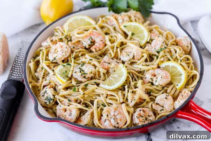 Zesty Lemon Garlic Shrimp Pasta 2 A pan of pasta with shrimp in a vibrant lemon-garlic sauce, ready to be served.