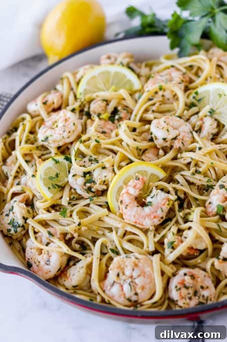 Lemon Garlic Shrimp Pasta Lemon Garlic Shrimp Pasta plated with a fork, showing the delicious sauce and perfectly cooked shrimp.