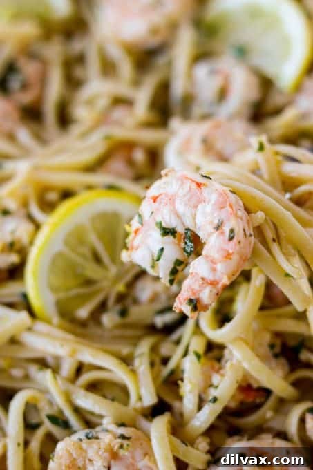 Zesty Lemon Garlic Shrimp Pasta 6 A large skillet of Lemon Garlic Shrimp Pasta garnished with fresh parsley, ready to be dished out.