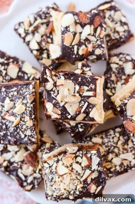 Silken Milk Toffee 3 Top-down view of beautifully prepared Condensed Milk Toffee squares on a baking sheet, sprinkled with almonds.