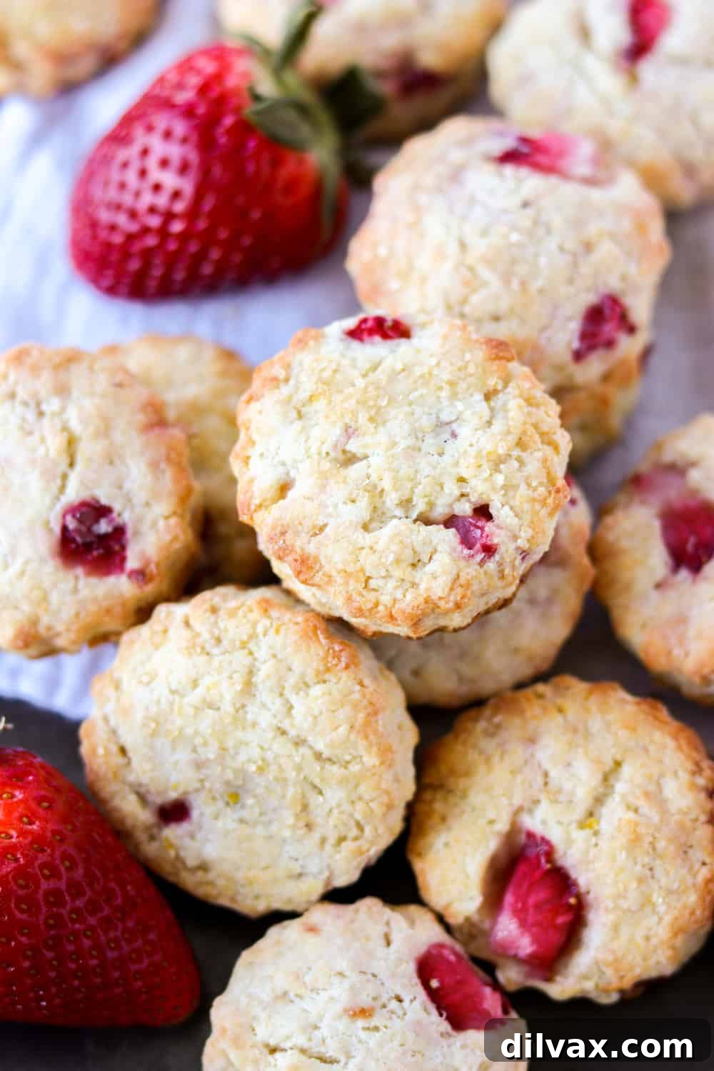 A beautifully arranged stack of golden-brown strawberry cream cheese scones, featuring glistening berries and a delicate texture, tempting you to enjoy a perfect homemade treat.