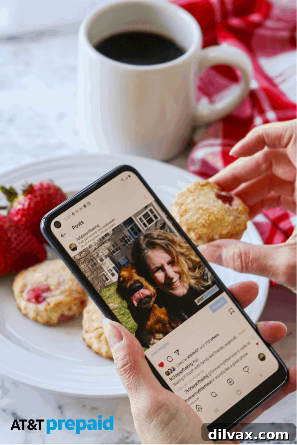 A person happily enjoying a homemade strawberry scone and a cup of coffee while engaging with their AT&T PREPAID smartphone, showcasing a blend of culinary delight and digital connectivity.