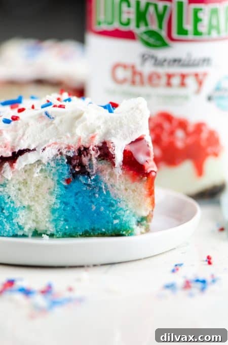Close-up of a red, white, and blue cake with a generous layer of Cherry Fruit Filling visible.