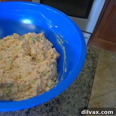 Buffalo chicken salad ingredients being mixed in a bowl