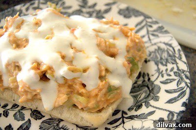 Buffalo chicken salad sandwich served with blue cheese dressing and celery and carrot sticks
