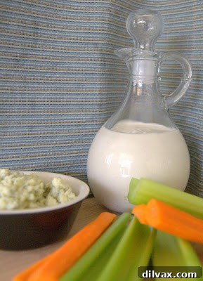 Bold Homemade Gorgonzola Dressing 5 A close-up shot of the finished creamy Gorgonzola blue cheese dressing in a clear glass jar.