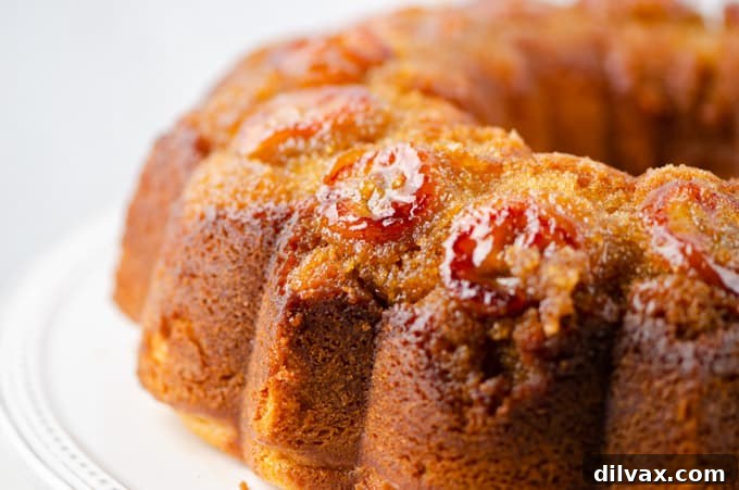 Peanut Butter Upside Down Banana Cake with sliced bananas in a brown sugar glaze, served with whipped cream.
