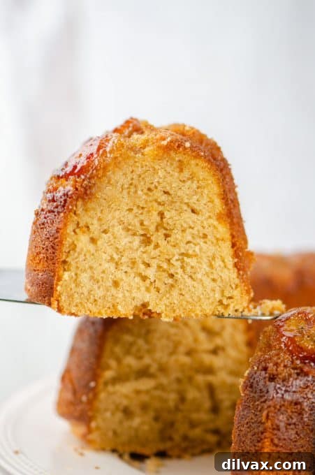 A perfectly sliced piece of Peanut Butter Upside Down Banana Cake showing the layers of banana and cake.